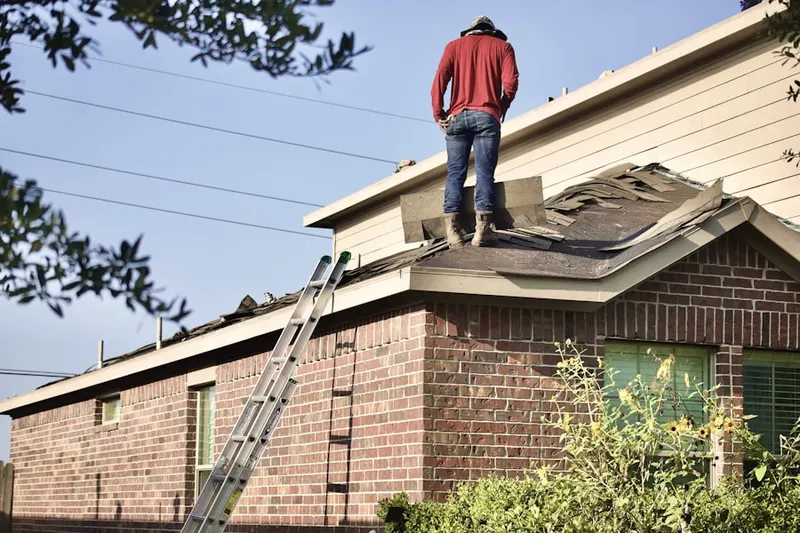 Professional roofer working on a residential roof in Winnemissett